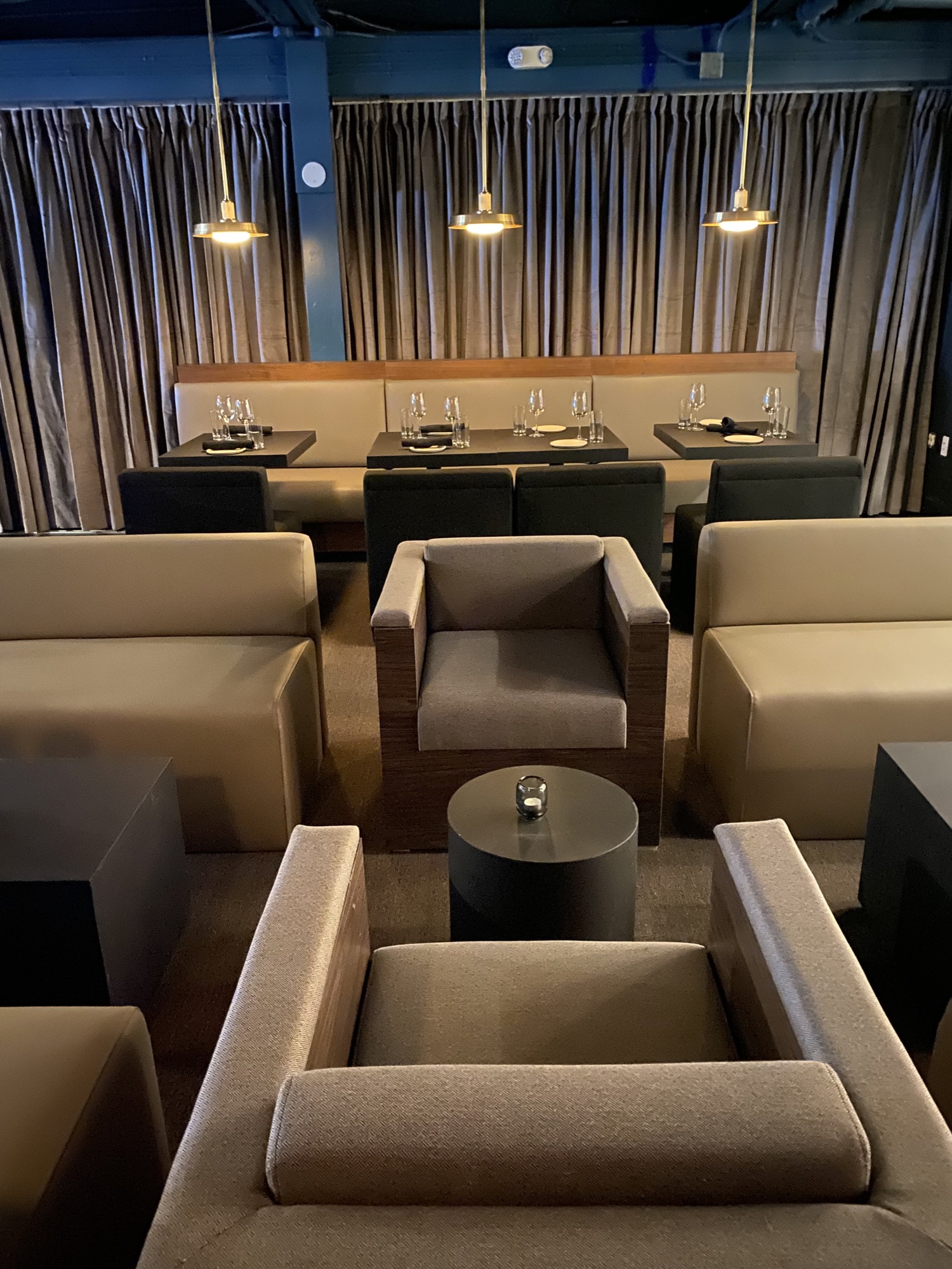 Lounge seating against a slatted wood wall at Pa’La