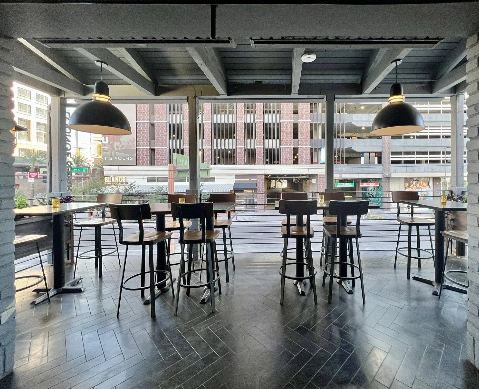 High-top tables along floor-to-ceiling windows at Pa’La