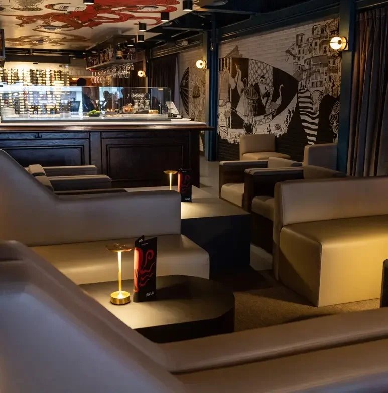 Low banquette lounge with warm pendant lighting at Pa’La