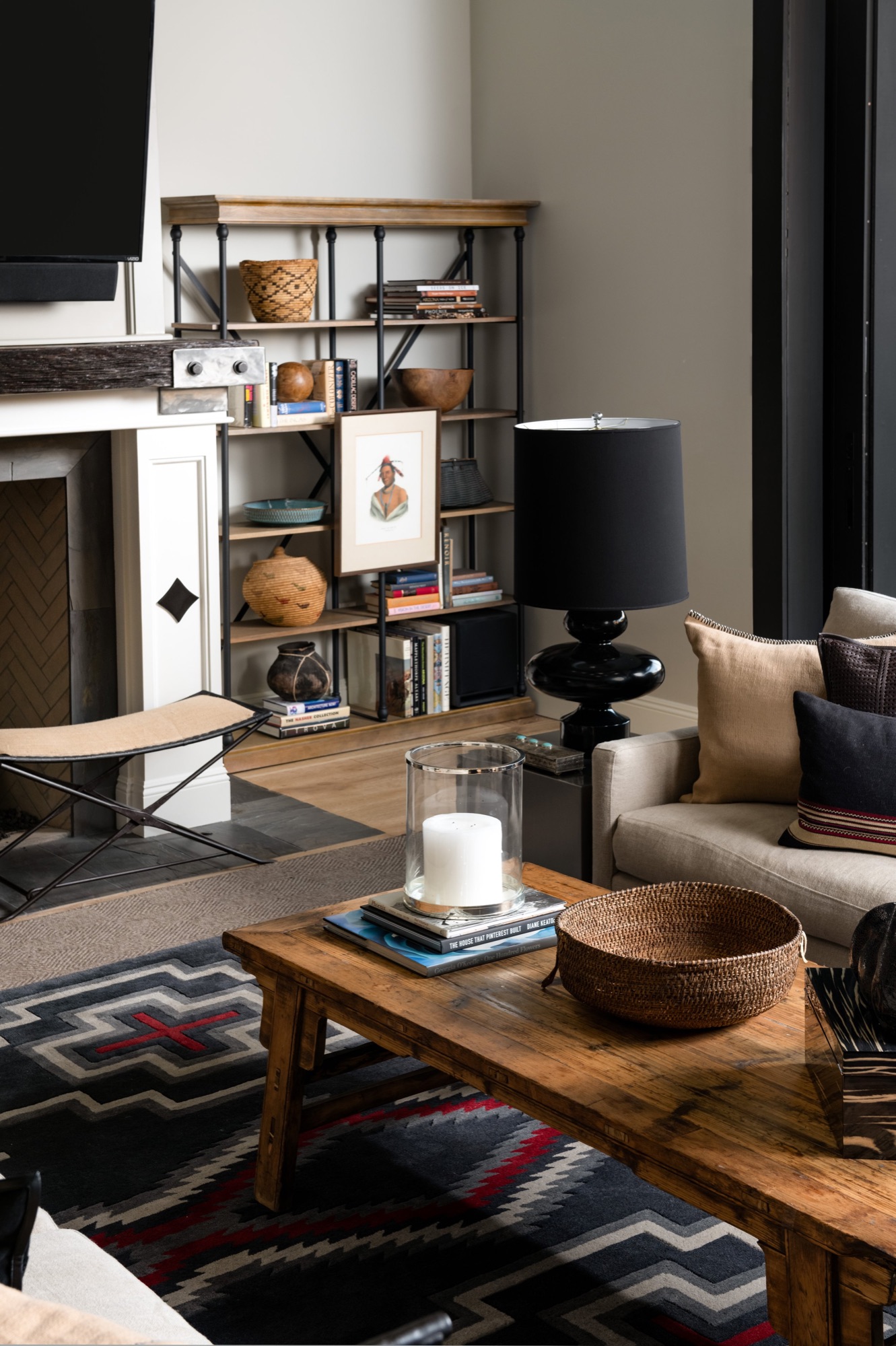 Library shelves with a table lamp and collected objects
