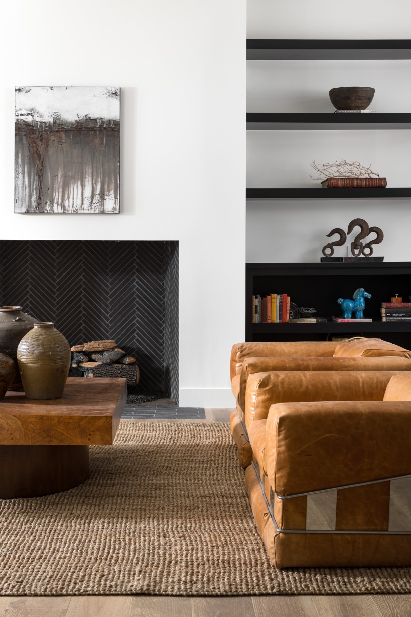 Living room with built-in shelving and leather club chairs