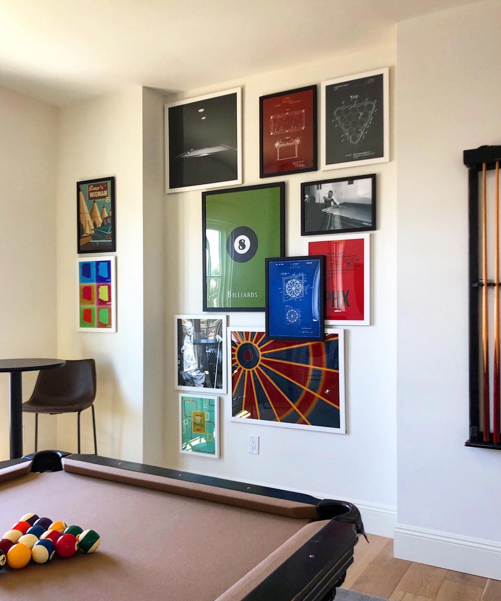 Game room with a billiards table and gallery wall